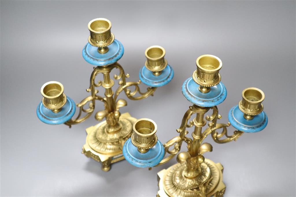 An early 20th century pair of ormolu and porcelain candelabra, with Sevres style plaques to base, height 28cm